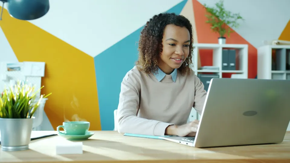 Smiling professional working successfully with a laptop