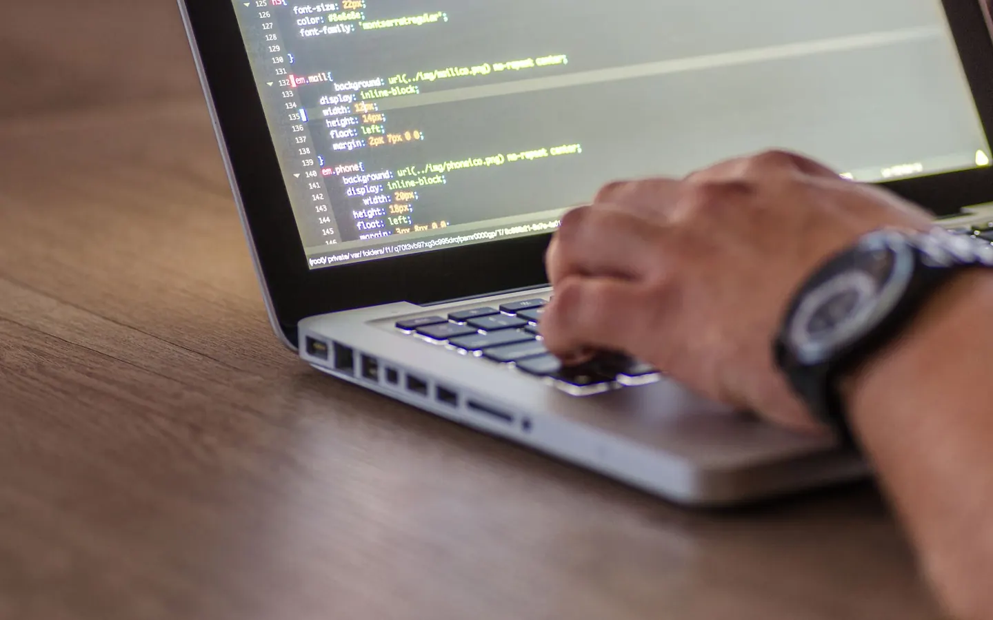 Developer reviewing code and API request parameters on a laptop
