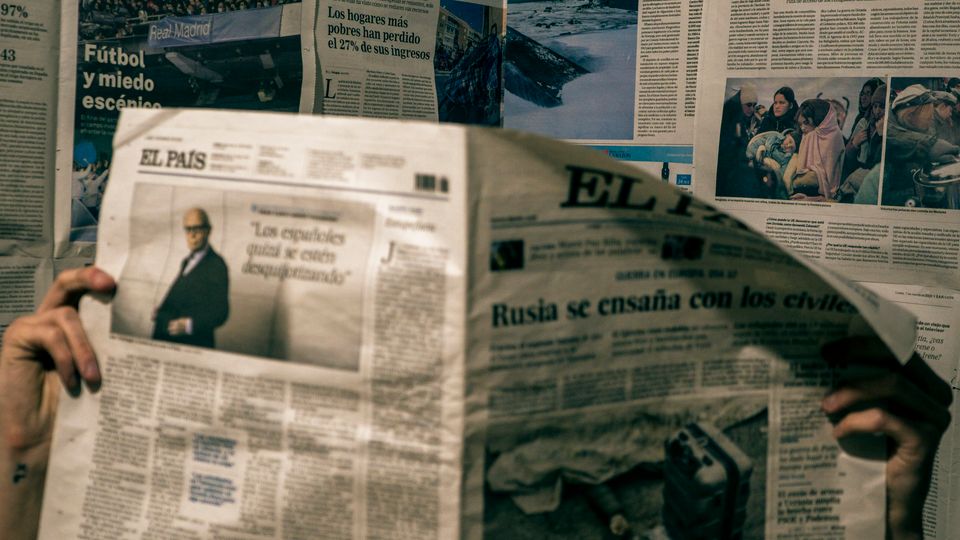 Person reading news articles in a room