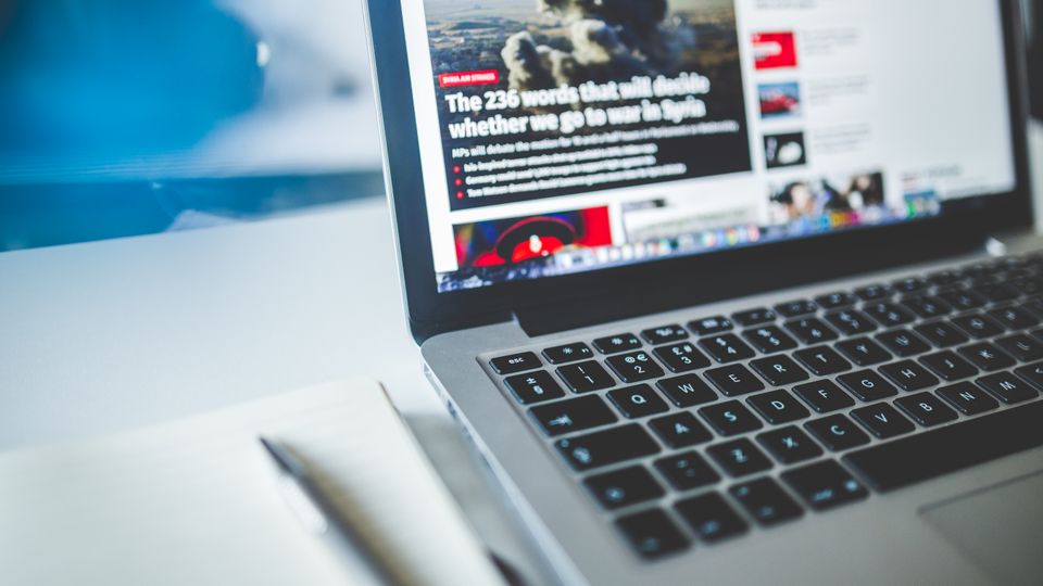 Laptop open on a news or content page