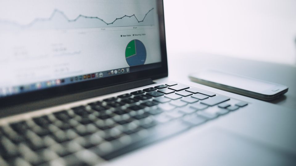 Laptop with analytics charts for price monitoring
