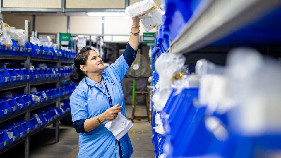 Warehouse worker organizing inventory shelves