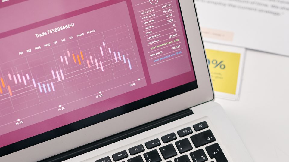 Laptop showing financial graphs and analytics