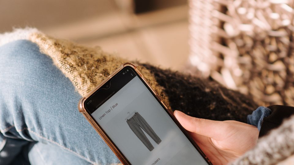 Person browsing products on a smartphone