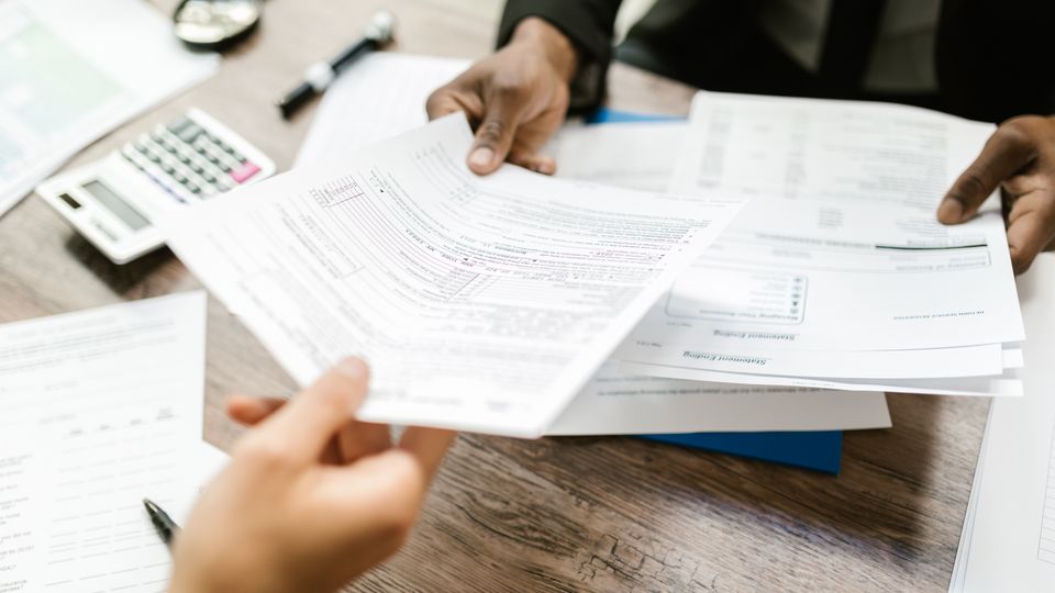 Professionals exchanging business documents